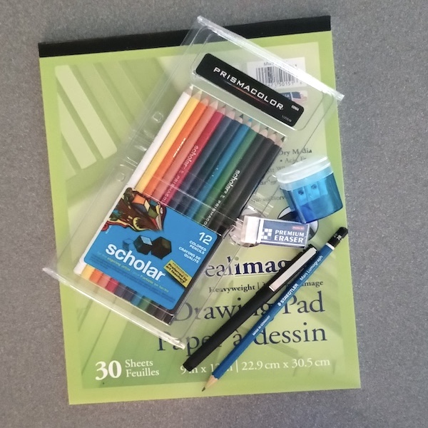 Drawing pad, colored pencils, sharpener, eraser, pen and pencil