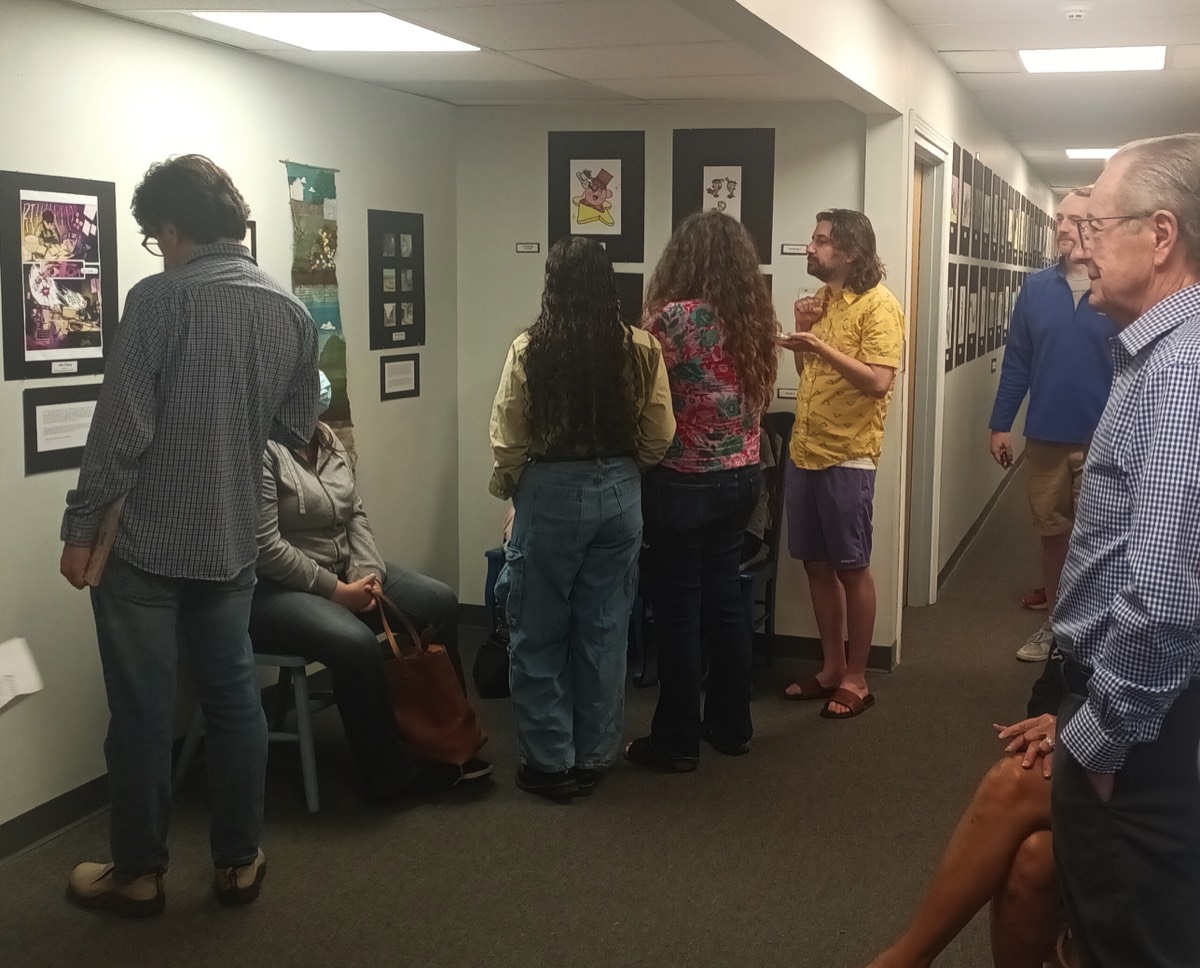 visitors looking at Graduating senios art wall